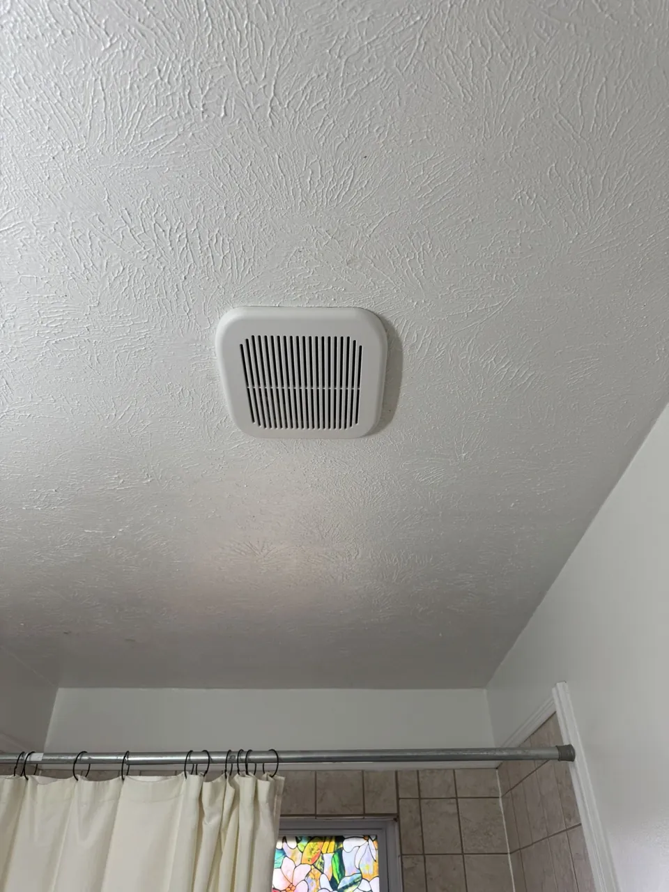 A wider view of the fan above the bathroom.
