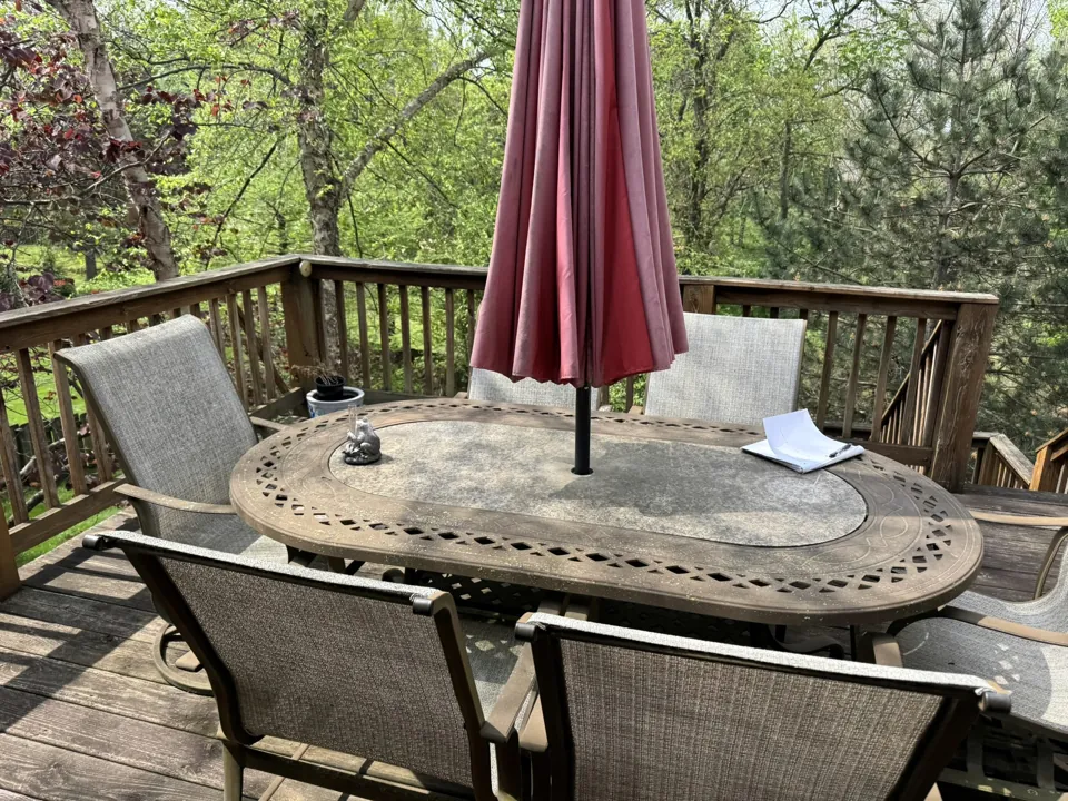 Weathered decking and railings on the upper outdoor level.
