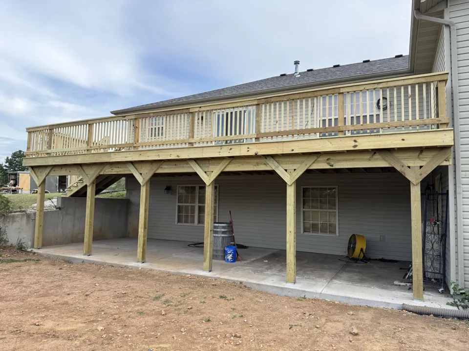 The deck, support posts, and new railings from the yard.