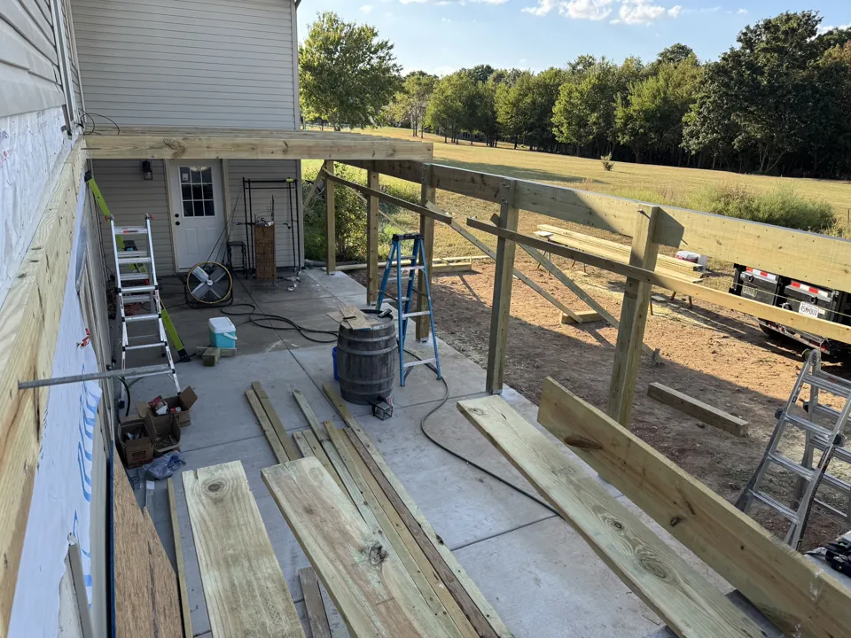 Deck framing beside the home.