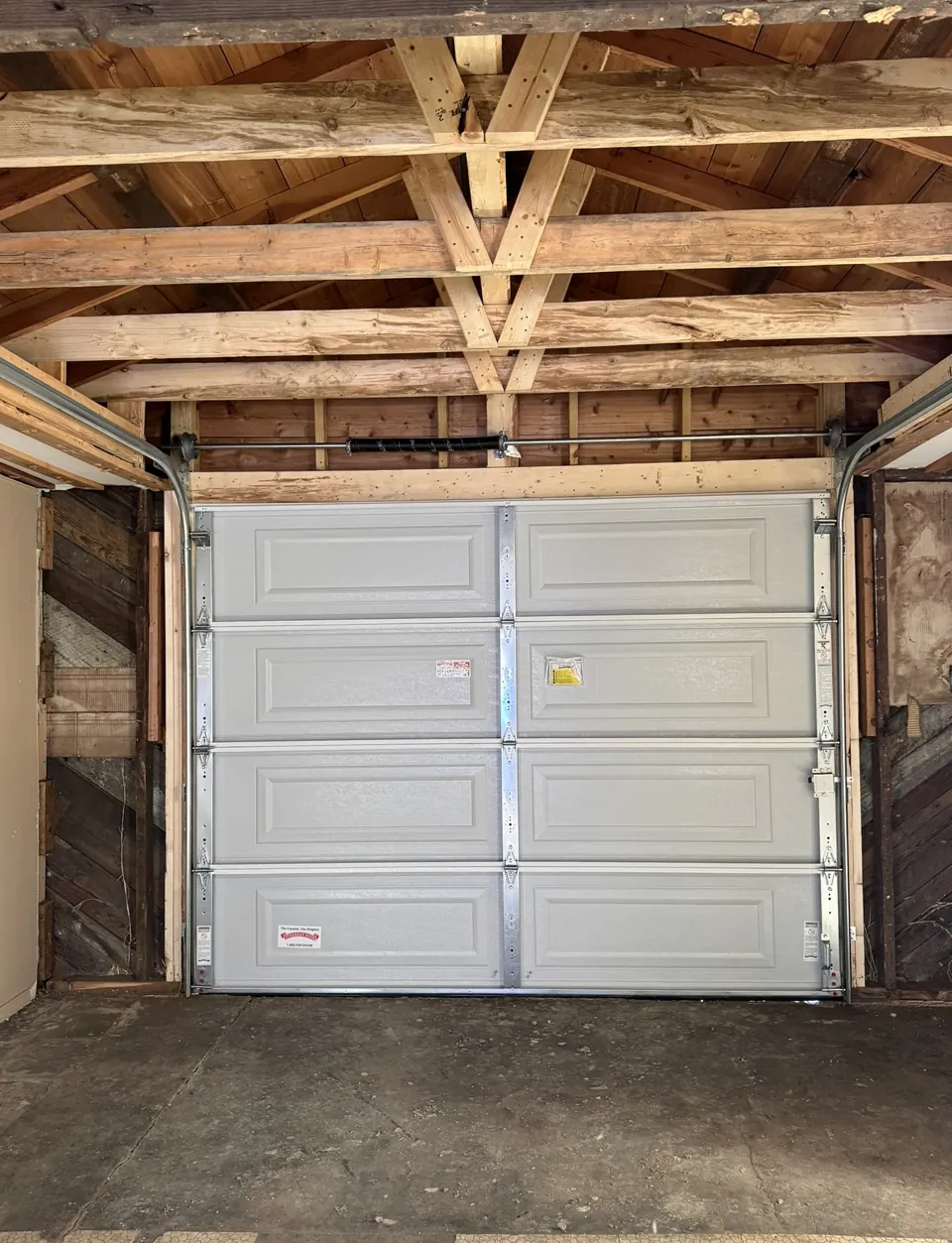 The installed sectional garage door viewed from inside.