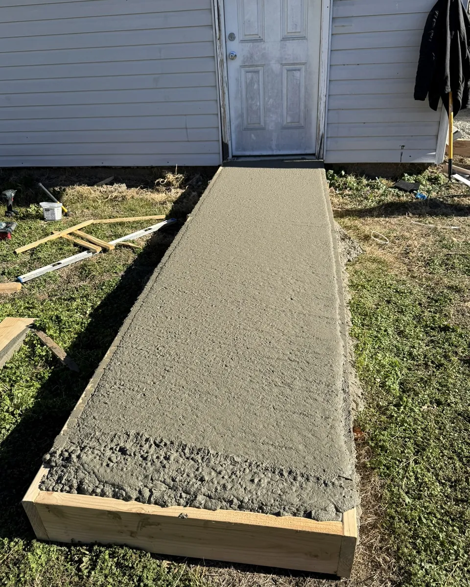 The newly poured walkway leading to the side entry.