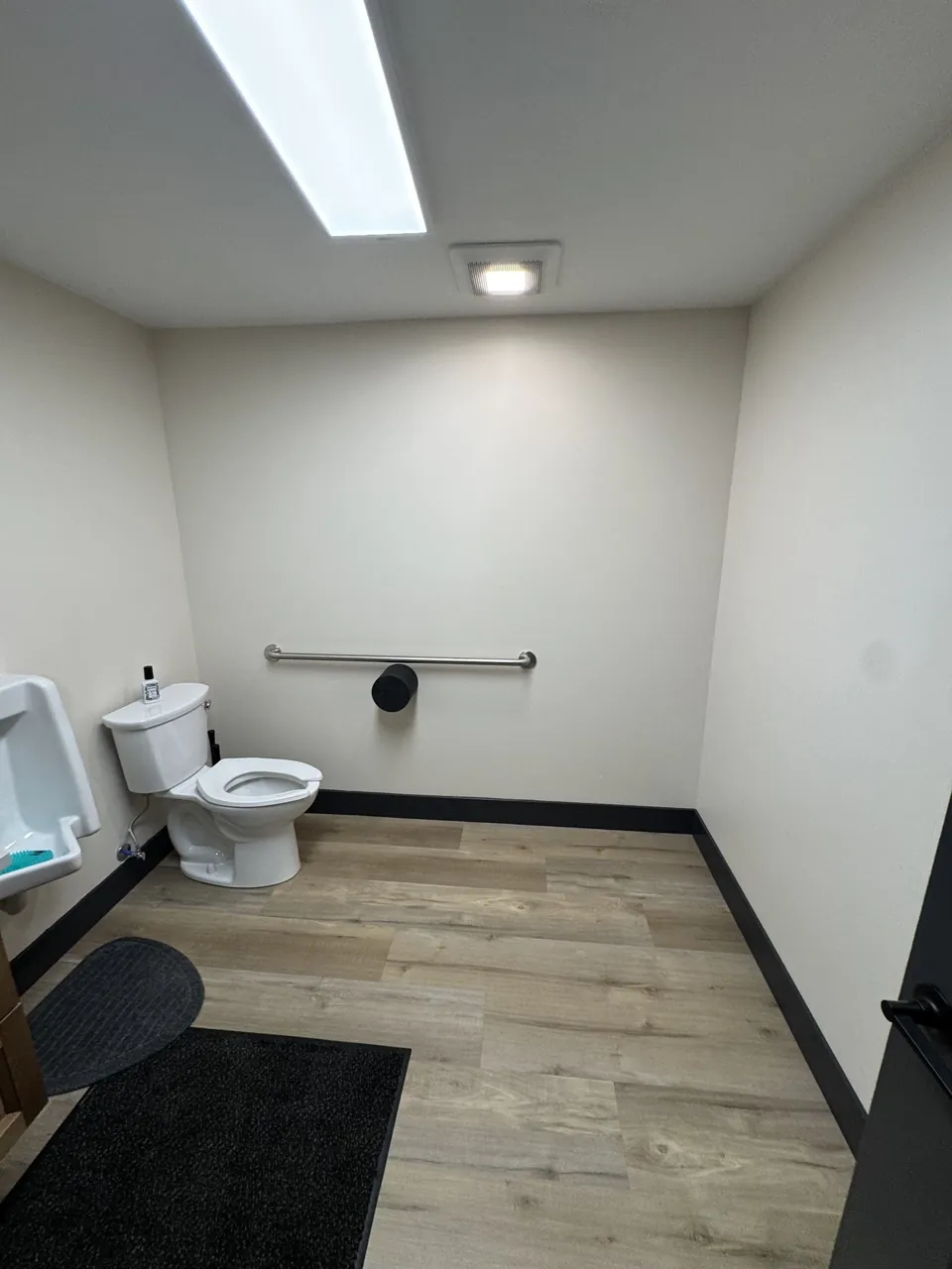 The updated restroom with its vanity and wall finishes.