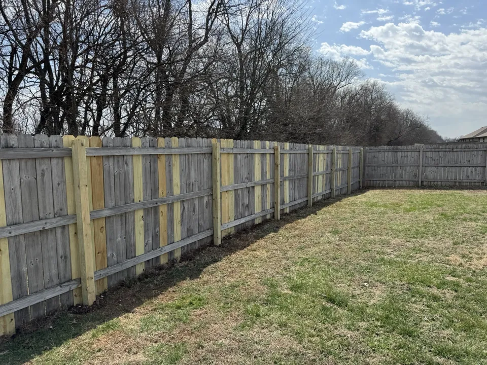 The repaired fence viewed toward the yard corner.